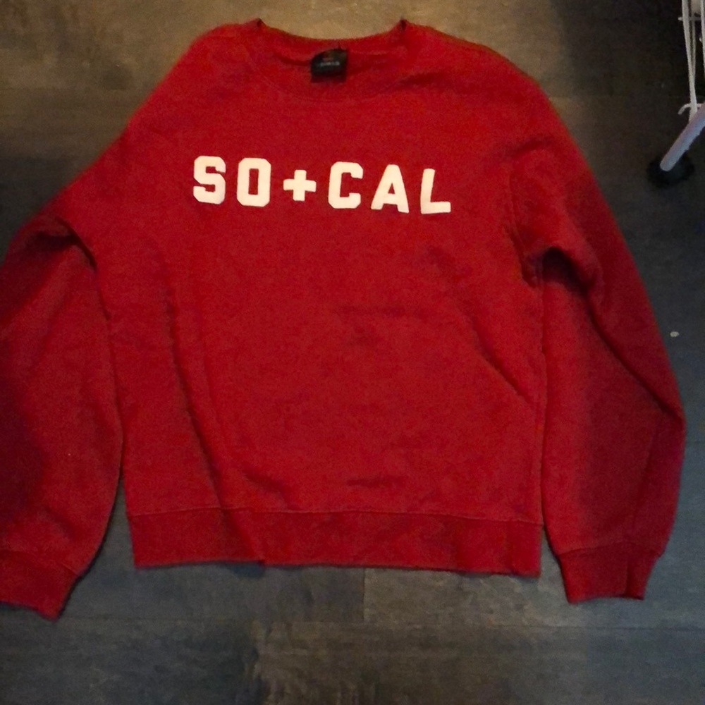 Red sweater with SO+CAL written in white